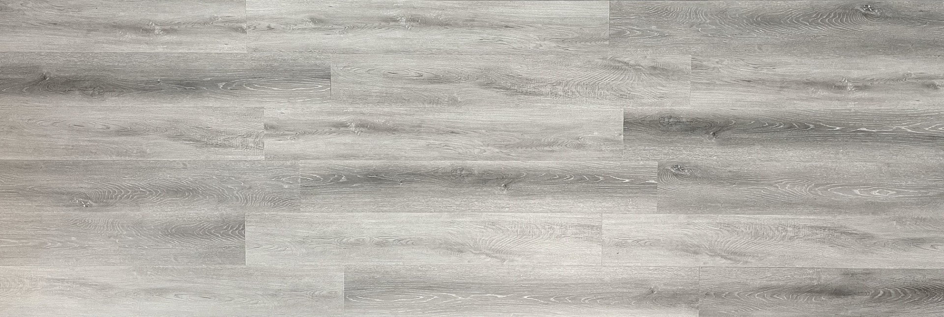 SPC flooring plank detail The rigid-core SPC plank scores with a utility knife and snaps cleanly — no power saw needed